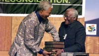 “Chairman of the TRC (Truth and Reconciliation Commission) Archbishop Desmond Tutu (R) hands over the TRC report to South Africa&#039;s President Nelson Mandela at the State theater Building in Pretoria on Oct. 29, 1998. South Africa&#039;s Truth Commission found that the ruling African National Congress is politically and morally accountable for gross human rights violations committed during its 30-year struggle against apartheid.” Credit: Reuters